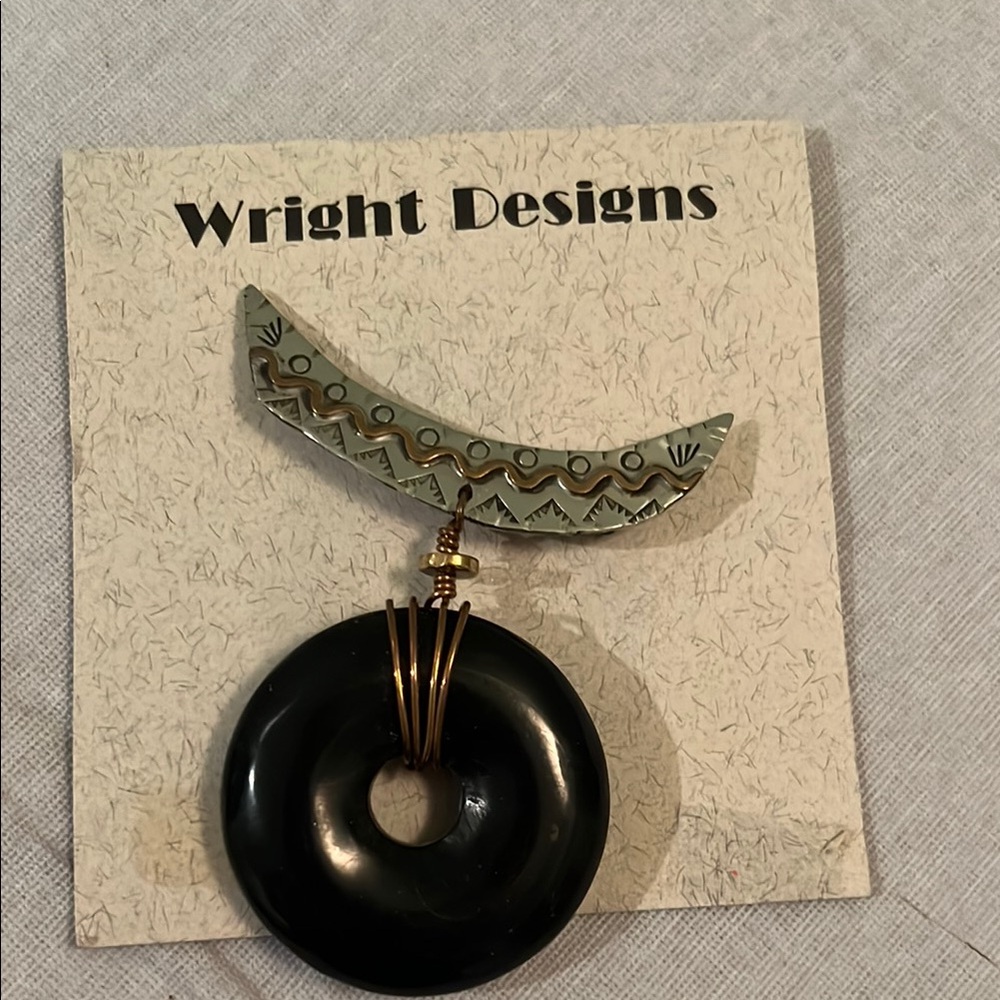 Black and Gold Brooch with Intricate Metalwork